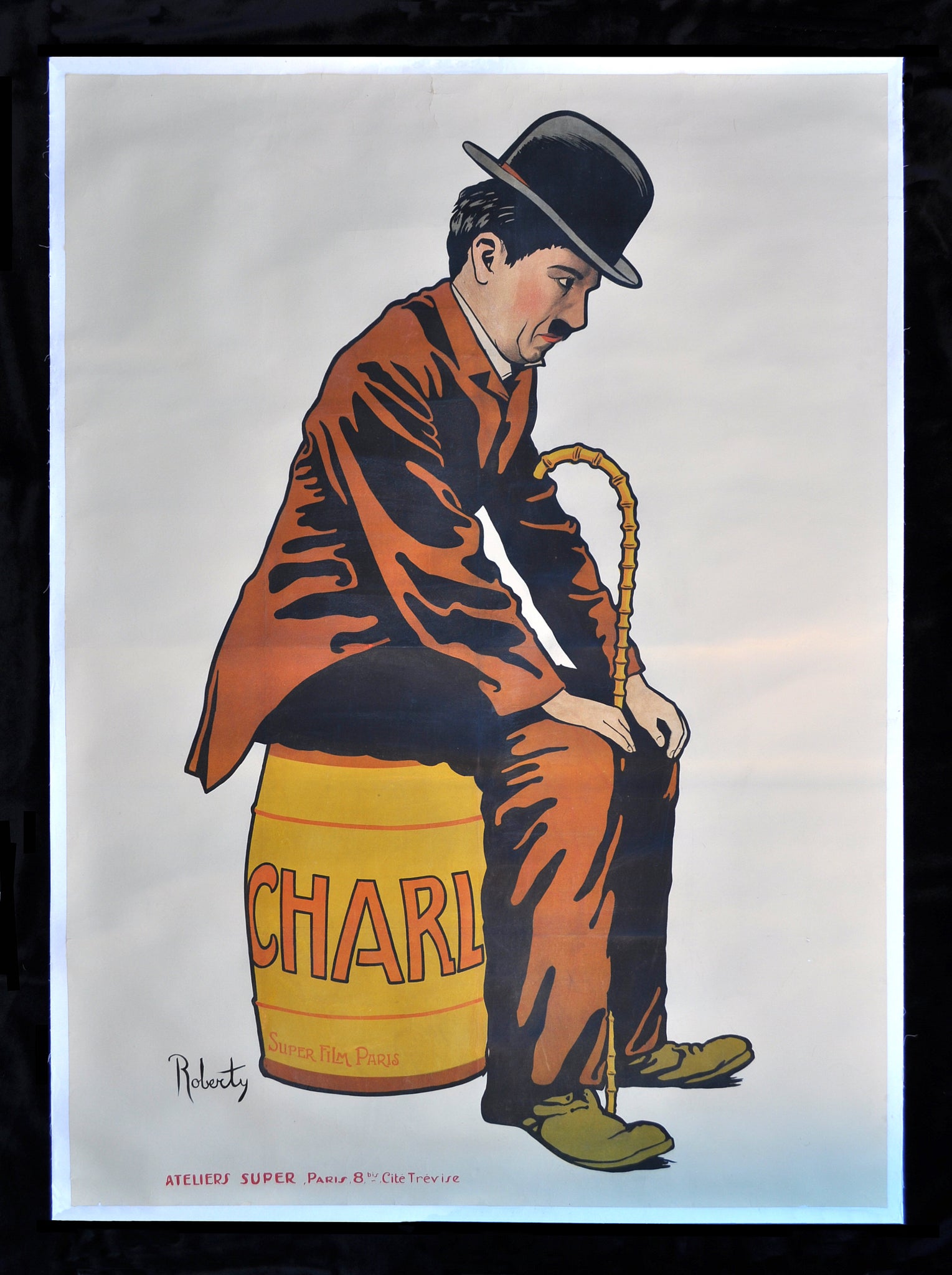 This is a vintage poster of English comic actor and filmmaker, Charlie Chaplin. It was designed by artist 'Roberty' to promote Chaplin's 1917 French film, 'Charlot'. Charlie Chaplin has left a huge legacy behind as one of the greatest comic writers and actors of all time and was a pioneer in the silent film era.